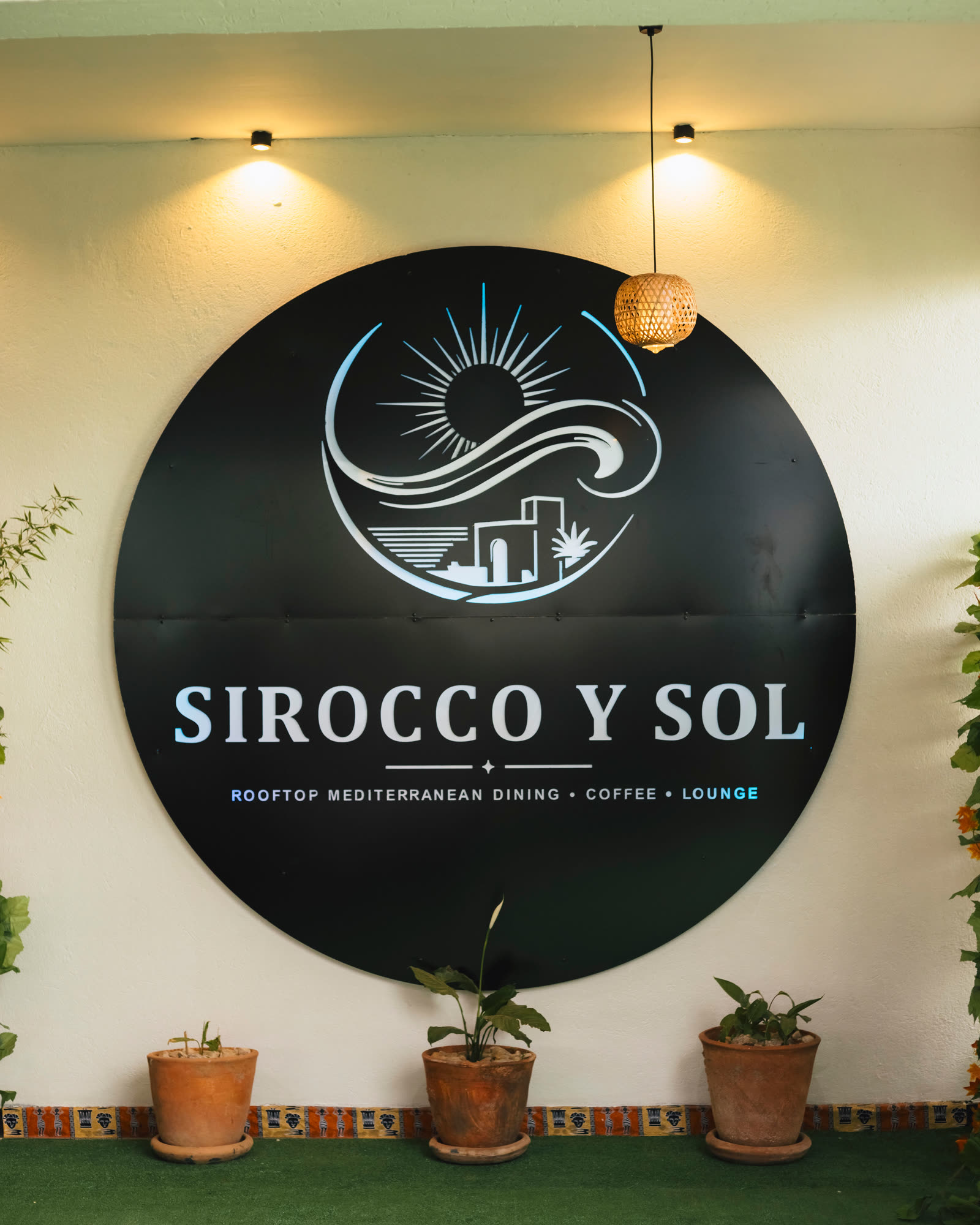 The Sirocco Y Sol sign on the rooftop — Rooftop Mediterranean Dining, Coffee, Lounge